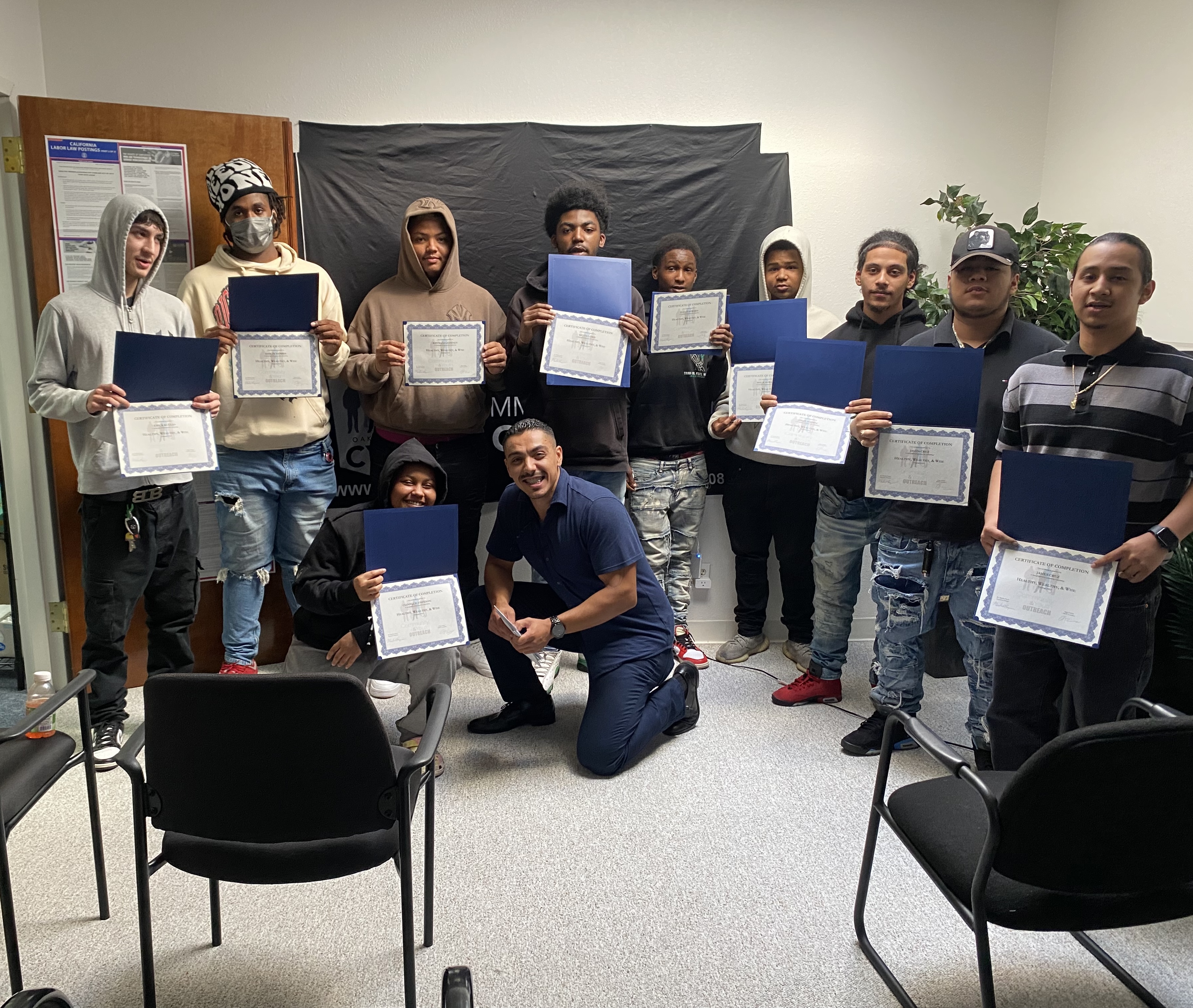Hugo with trainees holding certificates